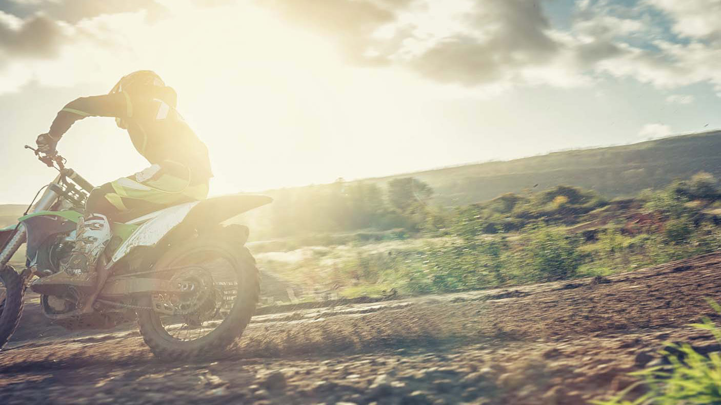 An close up image of a trail bike river on a dirt road