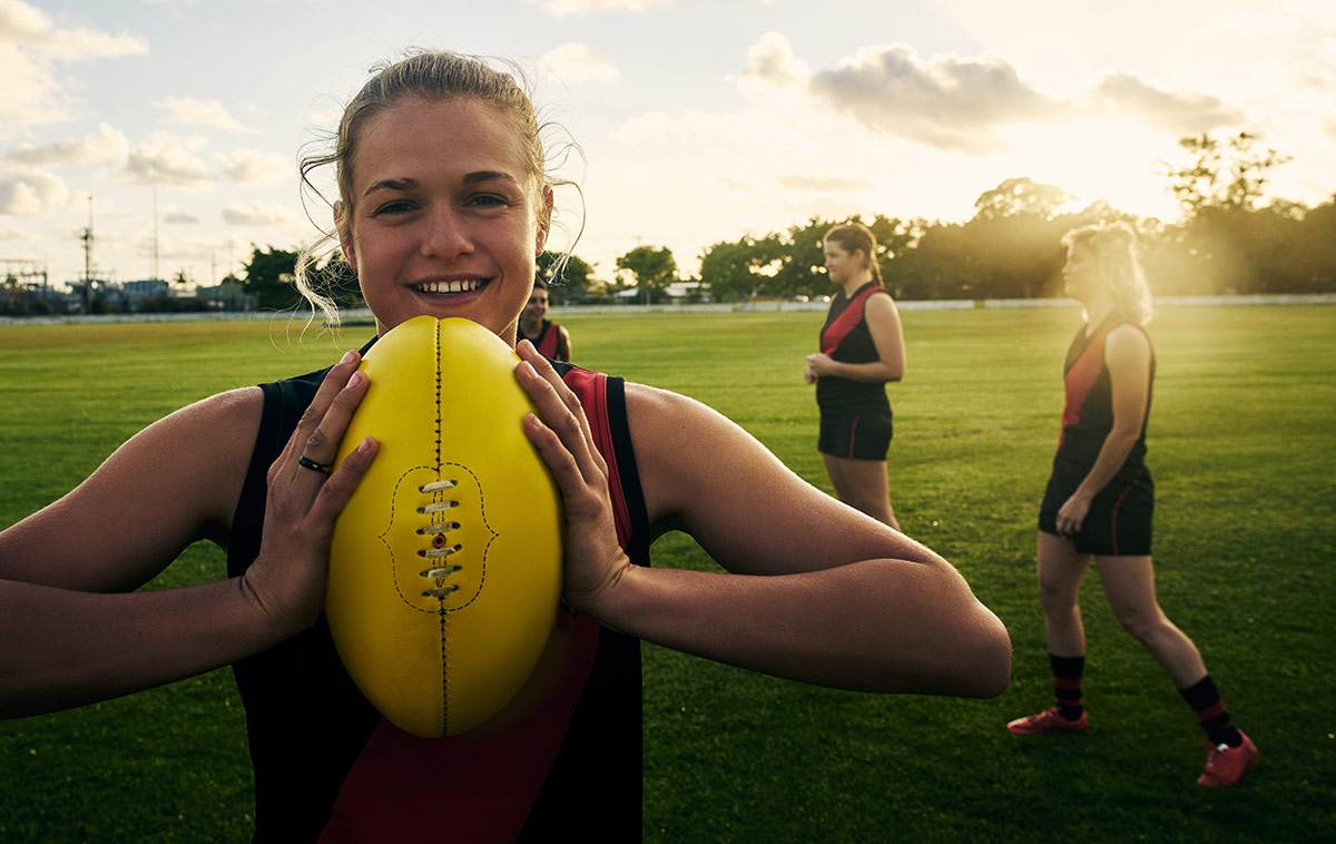 Female footballer holding a footbal