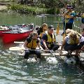 A group of adults getting on a raft