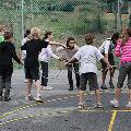 A group of participants in a circle holding a rope playing a ice breaker game